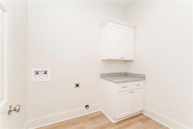 laundry room featuring cabinets, hookup for a washing machine, hookup for an electric dryer, and light wood-type flooring