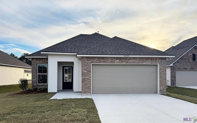 ranch-style house with concrete driveway, a front lawn, brick siding, a garage, and a shingled roof