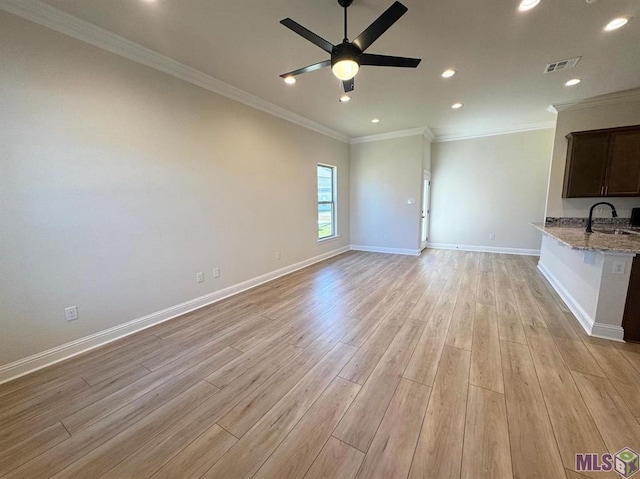 unfurnished living room with a ceiling fan, baseboards, light wood finished floors, and visible vents