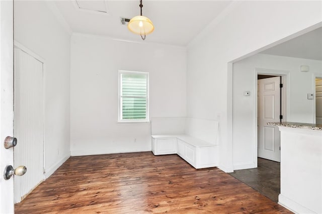 unfurnished room with crown molding, wood finished floors, baseboards, and visible vents