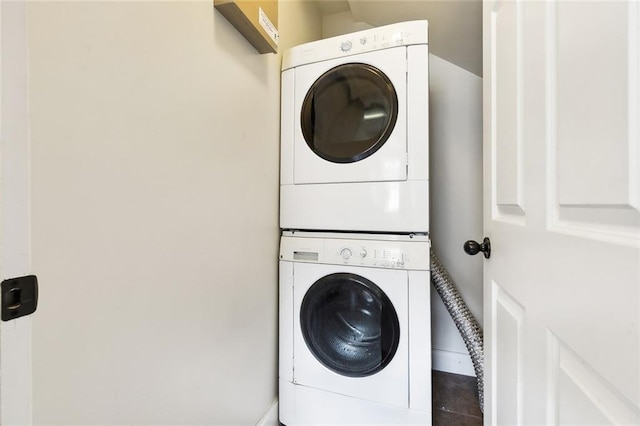 washroom featuring stacked washing maching and dryer