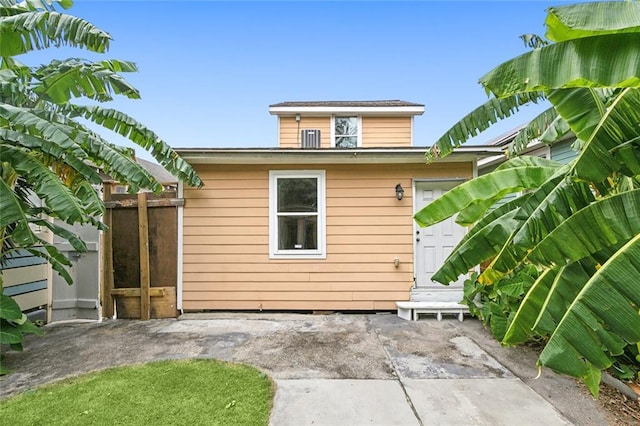 rear view of property featuring fence