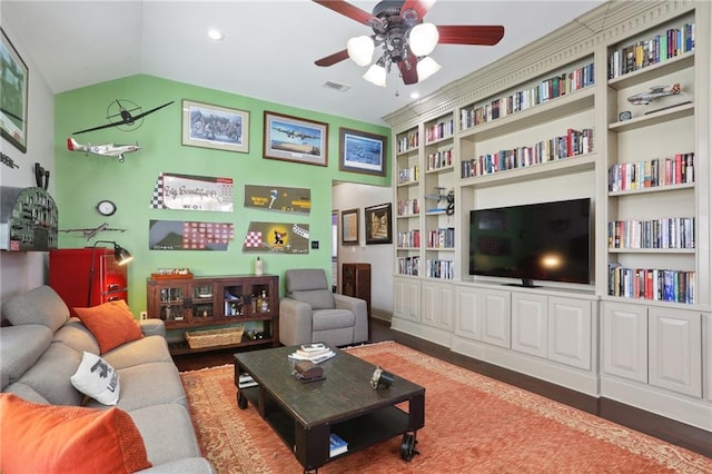 living room featuring ceiling fan, hardwood / wood-style flooring, built in features, and vaulted ceiling