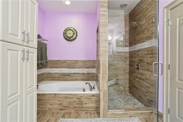 bathroom featuring separate shower and tub