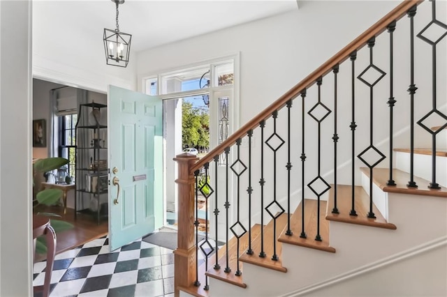 foyer entrance with a chandelier