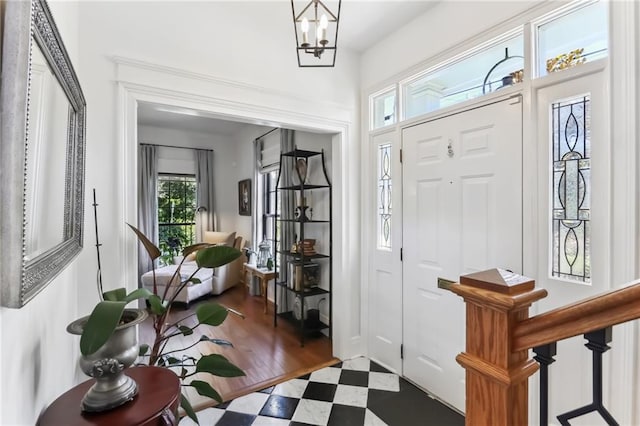 entrance foyer featuring a notable chandelier and dark hardwood / wood-style flooring