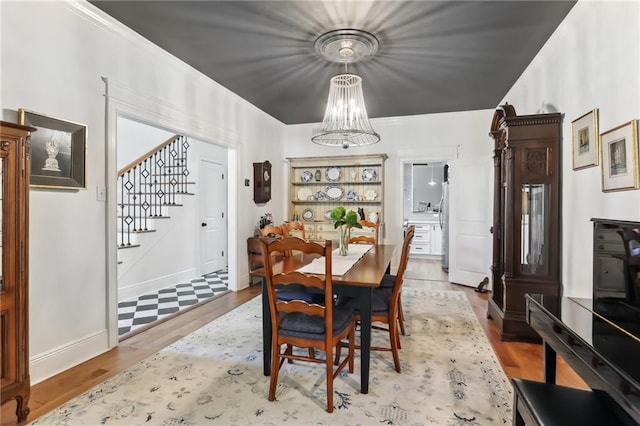 dining room with hardwood / wood-style floors and an inviting chandelier