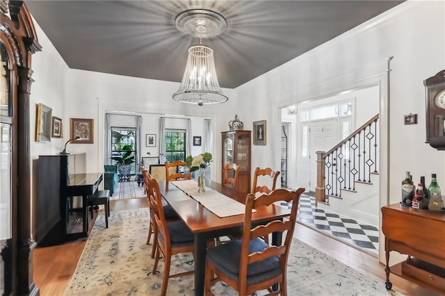 dining area featuring light wood-type flooring and a chandelier