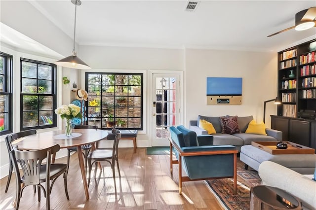 living room featuring ceiling fan and hardwood / wood-style flooring