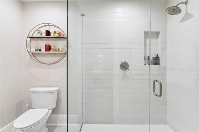 bathroom featuring toilet and an enclosed shower