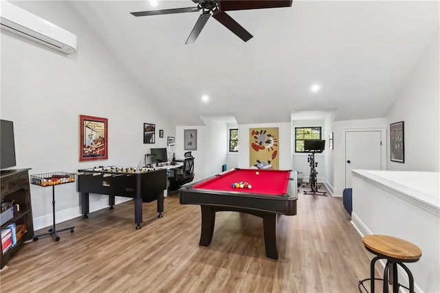 rec room with vaulted ceiling, ceiling fan, pool table, a wall mounted AC, and light hardwood / wood-style floors