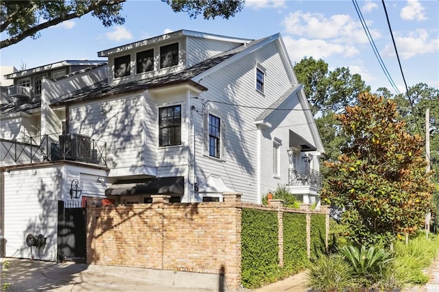 view of side of home featuring a balcony