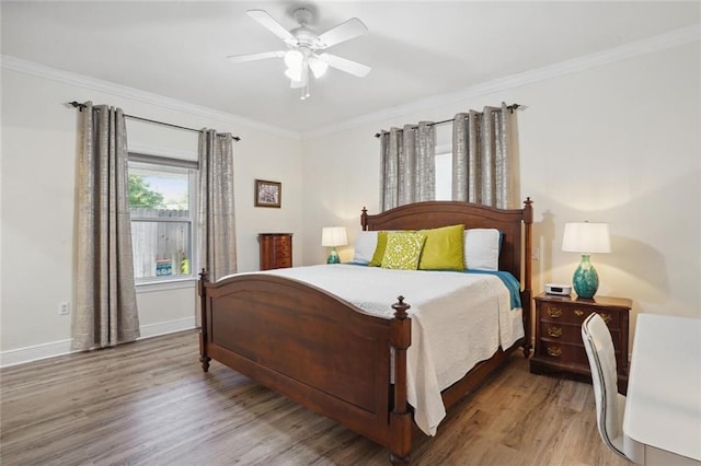 bedroom featuring ceiling fan, hardwood / wood-style floors, and ornamental molding