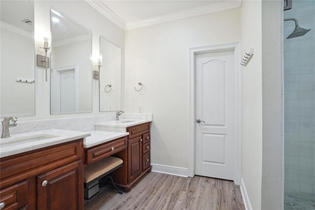 bathroom with crown molding, hardwood / wood-style floors, vanity, and an enclosed shower