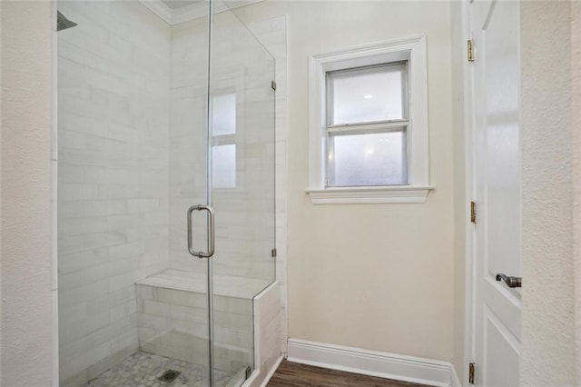 bathroom with hardwood / wood-style floors and a shower with door