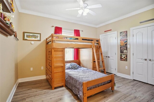 bedroom featuring ceiling fan, wood-type flooring, and ornamental molding