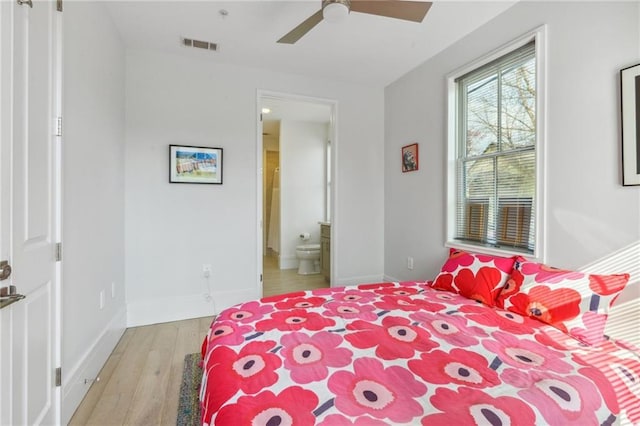 bedroom with ensuite bath, ceiling fan, and light wood-type flooring