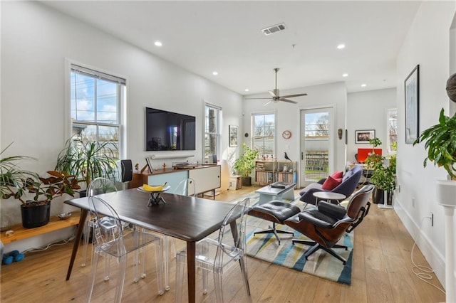 living room featuring ceiling fan and light hardwood / wood-style floors