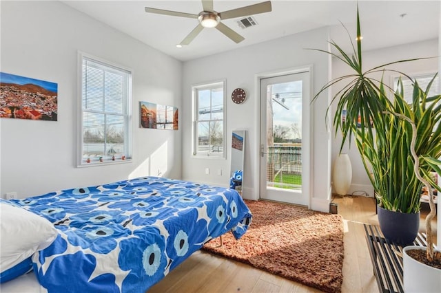 bedroom with ceiling fan and wood-type flooring