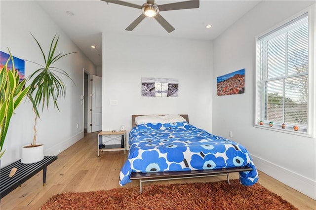 bedroom with ceiling fan and light wood-type flooring