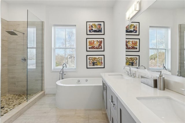 bathroom featuring tile patterned floors, vanity, separate shower and tub, and a wealth of natural light