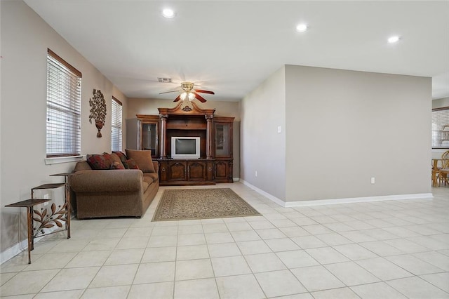 tiled living room with ceiling fan