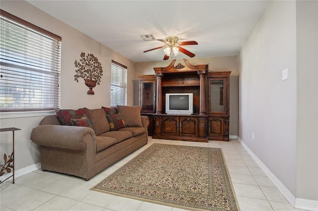 tiled living room featuring a wealth of natural light and ceiling fan