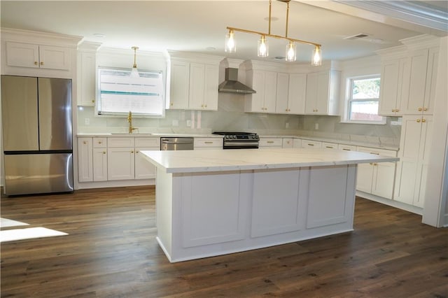 kitchen featuring a kitchen island, decorative light fixtures, stainless steel appliances, and dark hardwood / wood-style floors