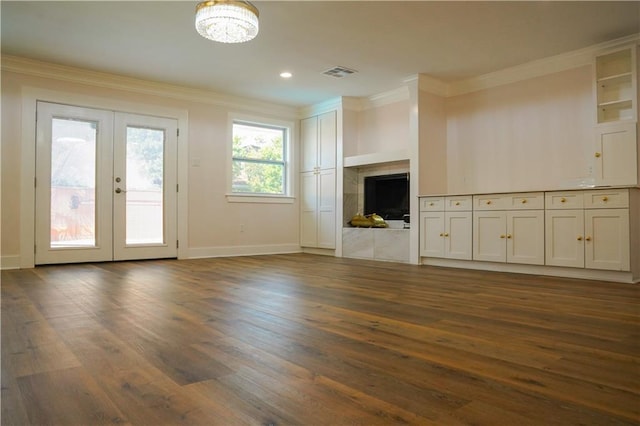 unfurnished living room with ornamental molding, french doors, a fireplace, and dark hardwood / wood-style floors