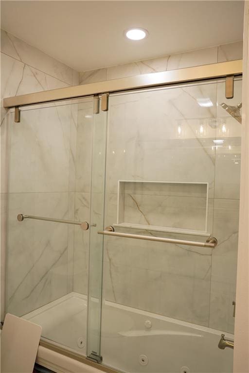 bathroom featuring bath / shower combo with glass door