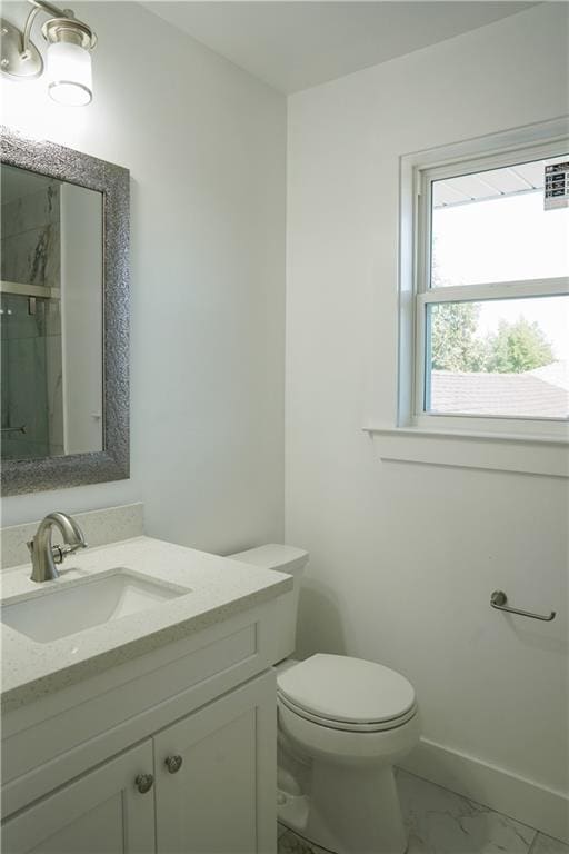 bathroom featuring vanity, toilet, and a shower with shower door