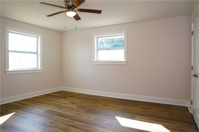 empty room featuring ceiling fan and dark hardwood / wood-style flooring