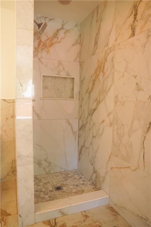 bathroom with tile walls and tiled shower