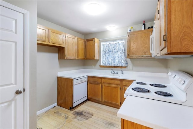 59449 Donya St, Slidell, LA 70460 - kitchen with light wood-style flooring, a sink, white appliances, brown cabinets, and light countertops