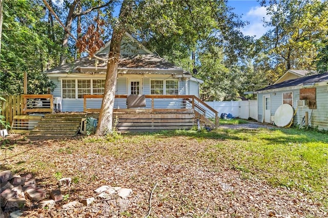 view of front facade featuring a front lawn and a deck