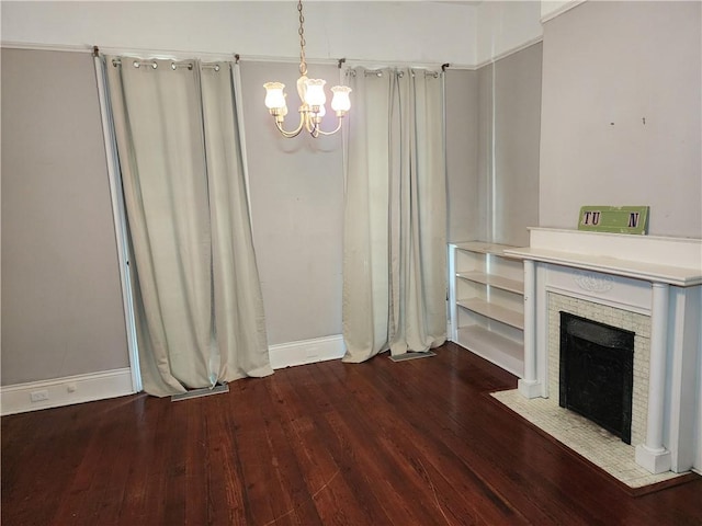 unfurnished living room featuring a chandelier and dark hardwood / wood-style flooring