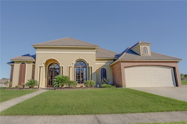 mediterranean / spanish home with a front lawn and a garage