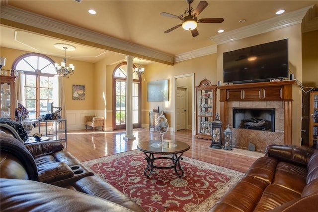 living room featuring light hardwood / wood-style floors, ornamental molding, plenty of natural light, and a fireplace