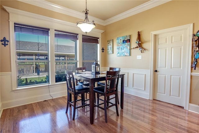 dining room featuring crown molding and hardwood / wood-style flooring