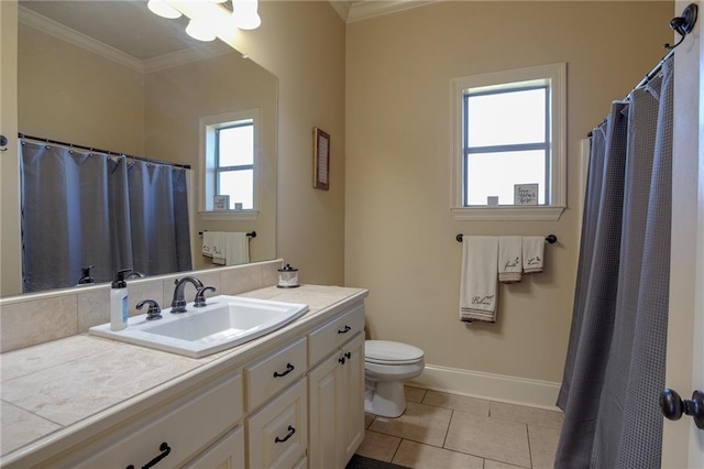 bathroom with vanity, toilet, a healthy amount of sunlight, and tile patterned floors