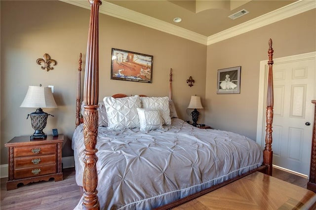 bedroom featuring hardwood / wood-style flooring and ornamental molding