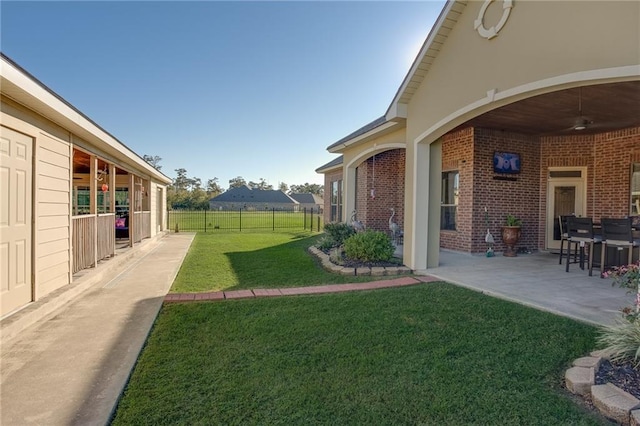 view of yard with a patio area and ceiling fan