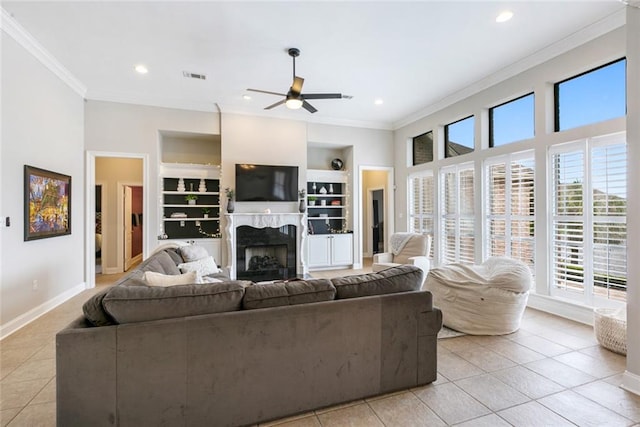 living room with crown molding, built in features, and light tile patterned floors