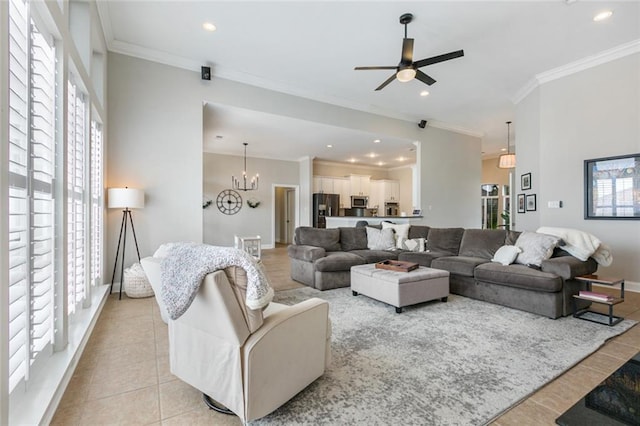 tiled living room with crown molding, ceiling fan with notable chandelier, and plenty of natural light