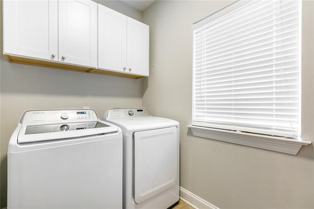 washroom featuring cabinets and independent washer and dryer