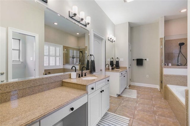 bathroom featuring vanity, independent shower and bath, and tile patterned flooring