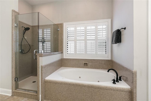 bathroom featuring shower with separate bathtub