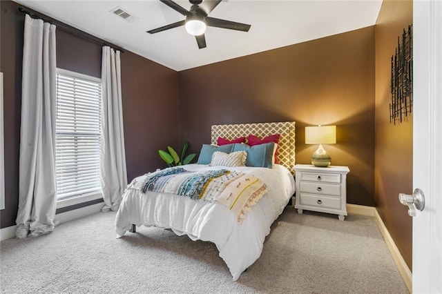 bedroom with light carpet and ceiling fan