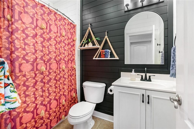 bathroom featuring toilet, vanity, and tile patterned flooring