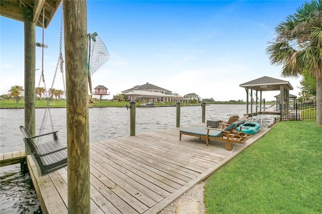 view of dock featuring a water view and a yard